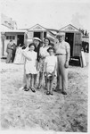 Members of the Kohn family pose outside a row of cabanas at the beach.