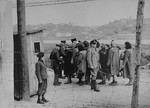 A group of Jewish women return to the ghetto after a day of forced labor on the outside.