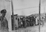 A group of Jews return to the ghetto after a day of forced labor on the outside.