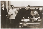 Soviet foreign minister Vyacheslav Molotov (seated) signs the Nazi-Soviet Non-Aggression Pact in Berlin.