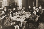 Robert Vermes (at the back head of the table, third from the right) entertains a group of friends at a bar mitzvah party in his home in Topolcany, Slovakia.