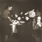 Swiss Red Cross workers distribute food to elderly Jews rescued from Theresienstadt in the Hadwigschulhaus in St.