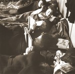 Jewish women rescued from Theresienstadt read while resting on their beds of straw in the Hadwigschulhaus in St.