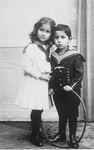 Studio portrait of Jewish siblings holding a hoop.