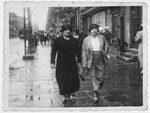 Bluma Shattan walks down a commercial street in Lodz with her sister-in-law Rivka