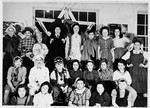 Group portrait of children dressed in Purim costumes in the Fort Ontario refugee center.
