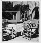 Julia Ensel sits on the terrace of her home with her mother Rosmarie Schink and stepfather, Dr.