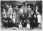The extended Brunn family gathers in front of their home in Szendro Hungary.