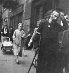 A Jewish man on the street in the Warsaw ghetto doffs his hat to Heinrich Joest (the photographer) in accordance with a humiliating order that Jews remove their hats in the presence of German personnel.