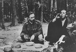 Members of the 27th division of the Armia Krajowa (Home Army) eat a meal in the woods in the Wolynia region.