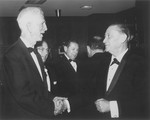 American Jewish philanthropist Abraham S. Kay (right) shakes hands with James G.