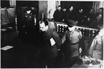 Defendant Ludwig Rehn is led out of the dock at the Sachsenhausen concentration camp war crimes trial in Berlin.