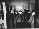 The defendants are led into the courtroom at the Sachsenhausen concentration camp war crimes trial in Berlin.