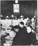 Defendant Anton Kaindl (right) stands in the dock at the Sachsenhausen concentration camp war crimes trial in Berlin.