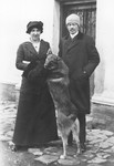 Dr. Adolf Huber and his wife Paola Huberova stand with their dog outside their home in Stara Tura, Slovakia.
