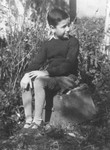 Portrait of nine-year-old Bedrich Deutsch sitting outside in a field in the Uhersky Brod ghetto.