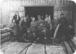 A group of young Zionists pose in front of a shed at a lumberyard in Bedzin prior to the departure of one of their members for Palestine.