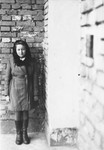 Lea Rein poses by a brick wall in Krakow after the war.