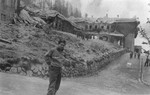 A Japanese-American soldier poses outside the destroyed Berghof, Hitler's mountain retreat in the Bavarian Alps.