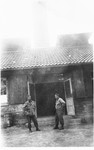 Two Japanese-American soldiers with the 522nd Field Artillery Battalion stand in front of the crematorium in the Dachau concentration camp soon after the liberation.