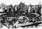 Soviet soldiers observe recently burned corpses stacked on sawed lumber on the grounds of the Klooga concentration camp.