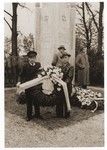 Jewish DPs from the Lechfeld displaced persons camp pose with a wreath in front of the memorial to Jewish victims at the Dachau concentration camp.