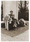 Gerzon Trzcina poses with a wreath in front of the memorial to Jewish victims at the Dachau concentration camp.
