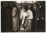 Lodz residents line up at an unidentified office in the ghetto.