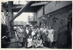 Group portrait of passengers aboard the Marine Perch who are immigrating to the United States after the war.