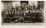 Group portrait of the employees of the Zentral Einkaufstelle, the central purchasing department of the ghetto which provided raw materials to the other ghetto workshops.