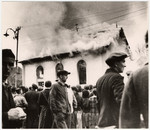 On the morning after Kristallnacht local residents watch as the Ober Ramstadt synagogue is destroyed by fire.