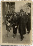 A Jewish family walks down a street in Lodz.