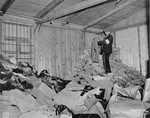 A member of the French resistance sorts through a warehouse filled with discarded prisoners' clothing in the Natzweiler-Struthof concentration camp.