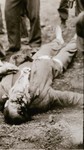 A guard shot by prisoners after their liberation.