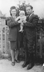 A Jewish couple poses with their young baby in Munich.