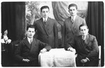 Studio portrait of four young men.  

One of them is Lezer Gliks.
