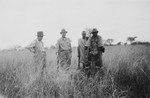 German Jewish refugee Heinrich Weyl poses with friends and an African employee in the bush while on a safari in Kenya.