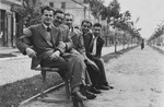 Five Jewish friends share a park bench by the side of a street in Siedlce.