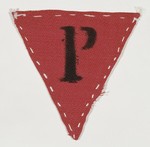 Red triangular badge worn by Polish political prisoner, Jadwiga Dzido, in the Ravensbrueck concentration camp.