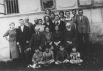 Group portrait of an extended Jewish family outside their home in Piotrkow Trybunalski, Poland.