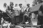 A group of Jews rides on the back of a horse-drawn wagon in Piotrkow Trybunalski, Poland.