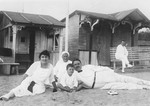 A Jewish family poses with their nurse on the beach at Tsin Tzo.