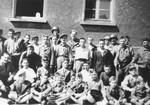 Group portrait of child survivors of Buchenwald taken outside a barracks prior to their departure for France and Switzerland.
