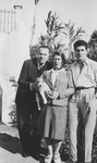 A Jewish refugee family poses outside with their dog in Ericeira, Portugal, after their escape from German-occupied France.