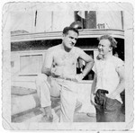 Eli Kalm (left) and William Bernstein, crew members of the President Warfield/Exodus 1947, converse on the deck of the ship before its departure for Europe.