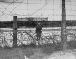 A Hungarian sentry guarding the perimeter at Bergen-Belsen concentration camp.