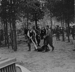 British soldiers force former SS guards to remove for burial the corpses of prisoners killed in Bergen-Belsen concentration camp.