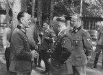 Reichsfuehrer-SS Heinrich Himmler converses outside with Rudolf Schmundt at Wolfsschanze (Wolf's Lair), Hitler's field headquarters in Rastenburg, East Prussia.