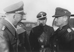 Reichsfuehrer-SS Heinrich Himmler converses with a group of officers.