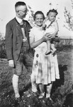 Heinrich and Margarete Himmler pose outside in a yard with their infant daughter Gudrun.